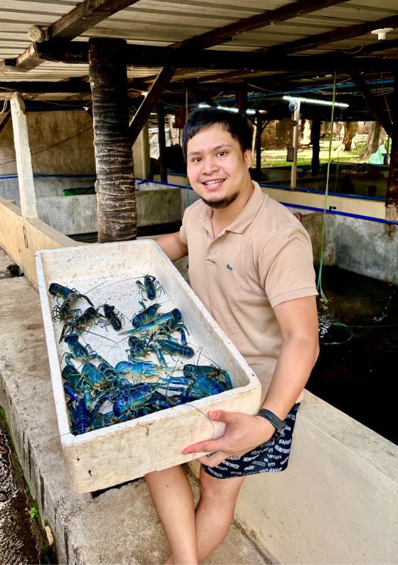 Sesep's Farm founder holding premium blue Red Claw Crayfish broodstock
